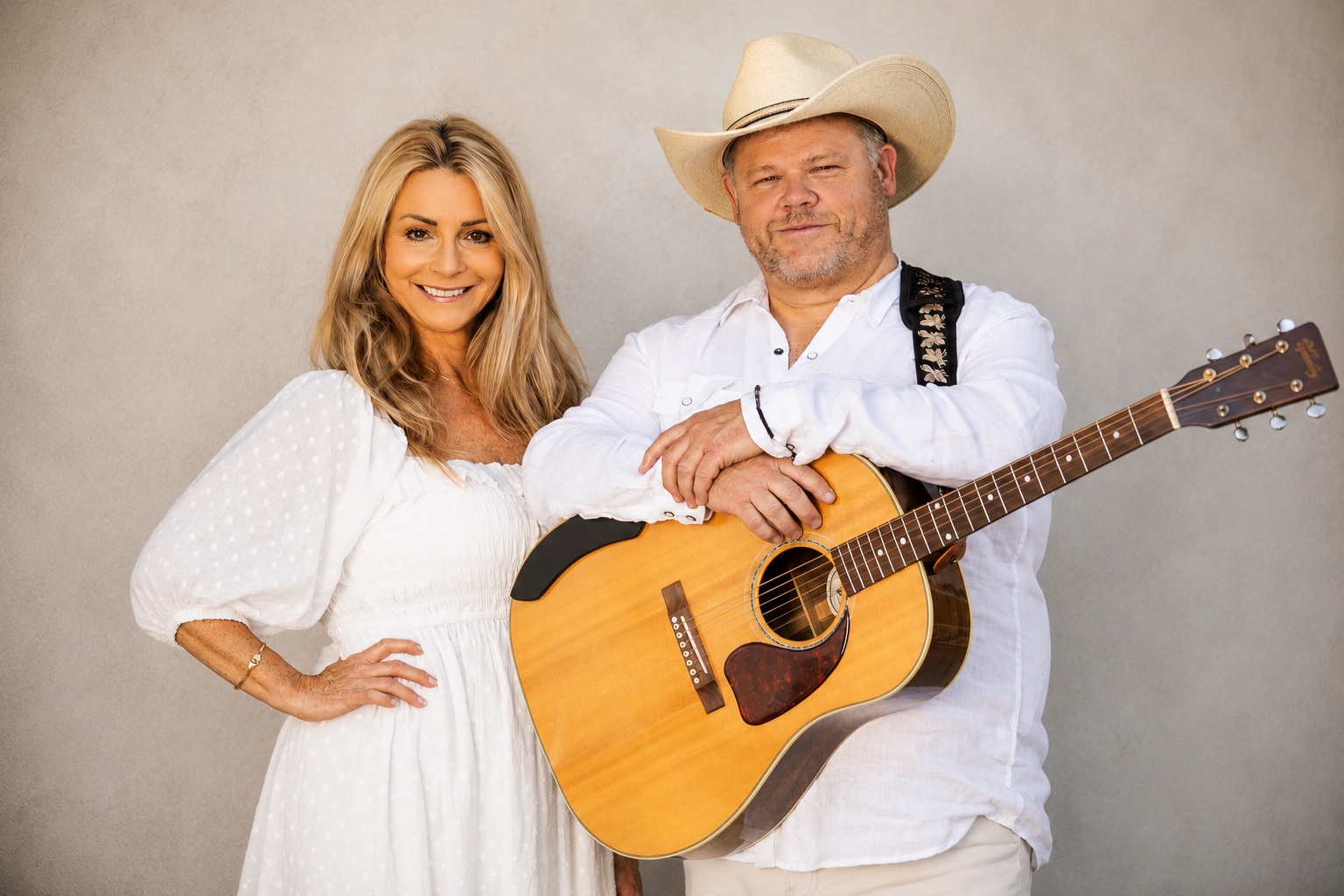 Tracie and Mike of 6 Feet Apart Music with an acoustic guitar